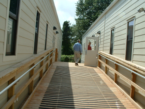 Schools Superintendent Edward Seto, left, and buildings and grounds supervisor Rick Goetz enter one of the new portable classrooms at Sampson G. Smith School.